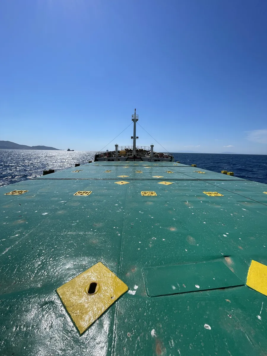 Green hatch covers with yellow cleat plates, looking towards the bow