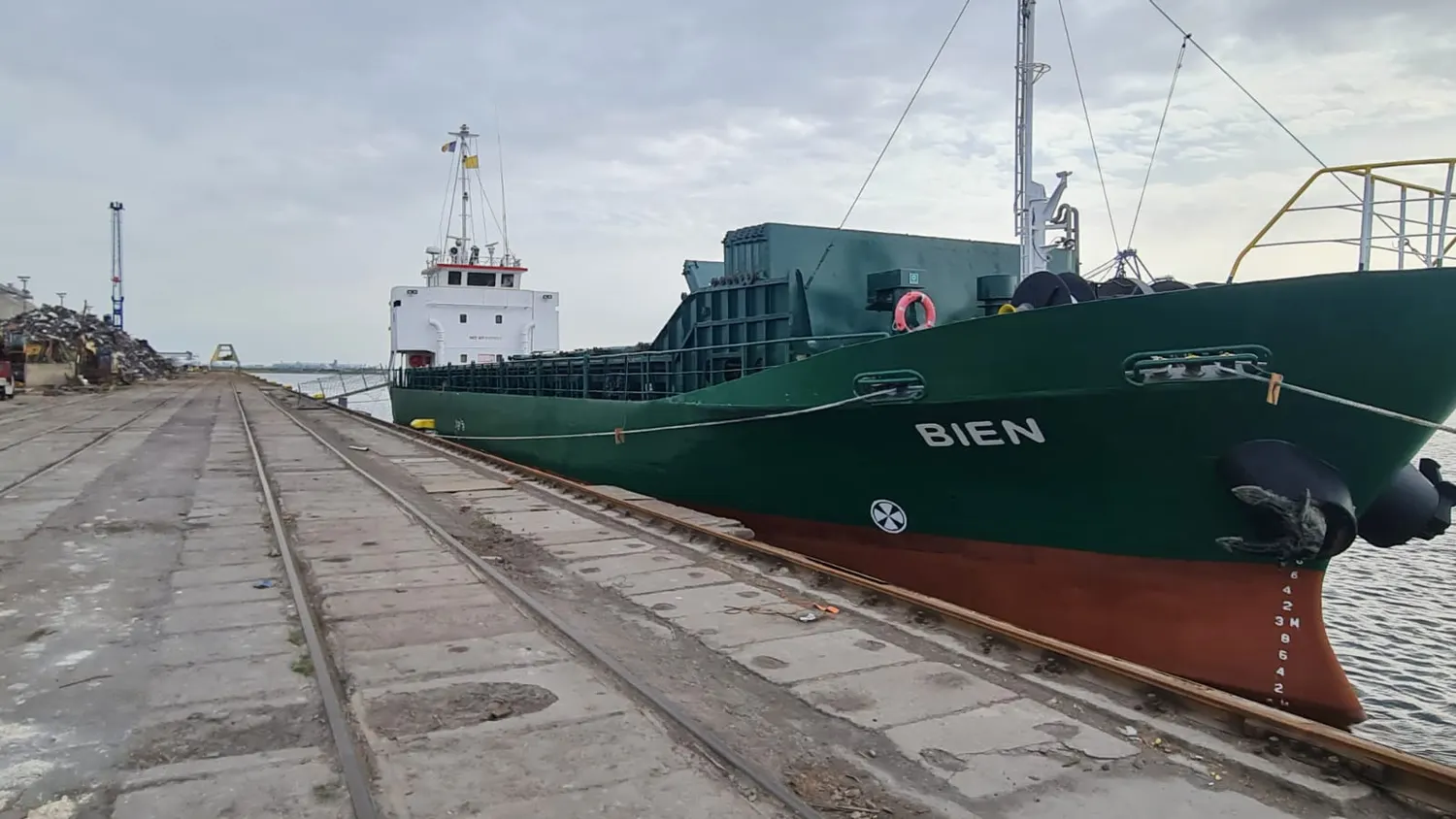 A general cargo vessel lying alongside a quay